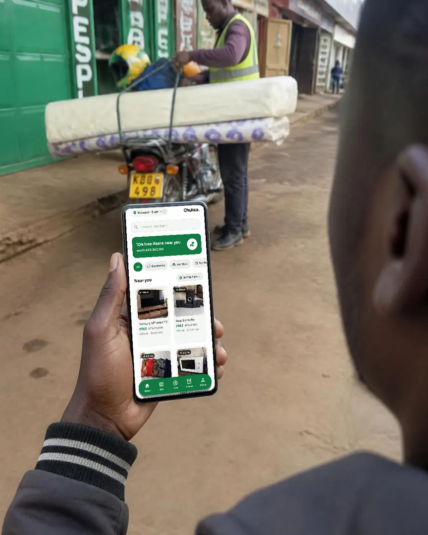 Over the shoulder: the Chukua feed on a phone while a boda rider straps on a mattress